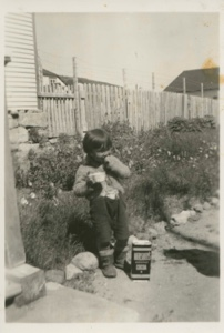 Image of Eskimo [Inuk] boy - student at MacMillan School, with Hershey cocoa